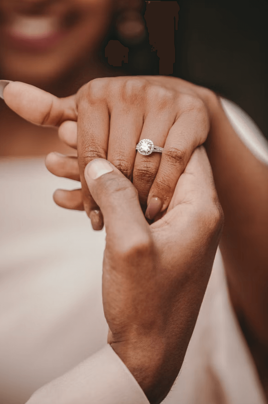 Couple holding hands with a modern engagement ring, exemplifying top Montreal wedding trends for 2024, focusing on elegance and 4Cs.