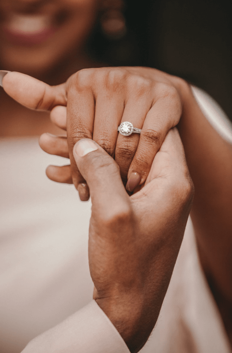 Close-up of couple's hands showcasing an engagement ring, symbolizing love and proposal ideas in Montreal by Maison Karat.