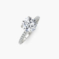 Load image into Gallery viewer, Classic solitaire engagement ring with a round brilliant diamond set in 14k white gold, showcasing elegant jewelry craftsmanship.
