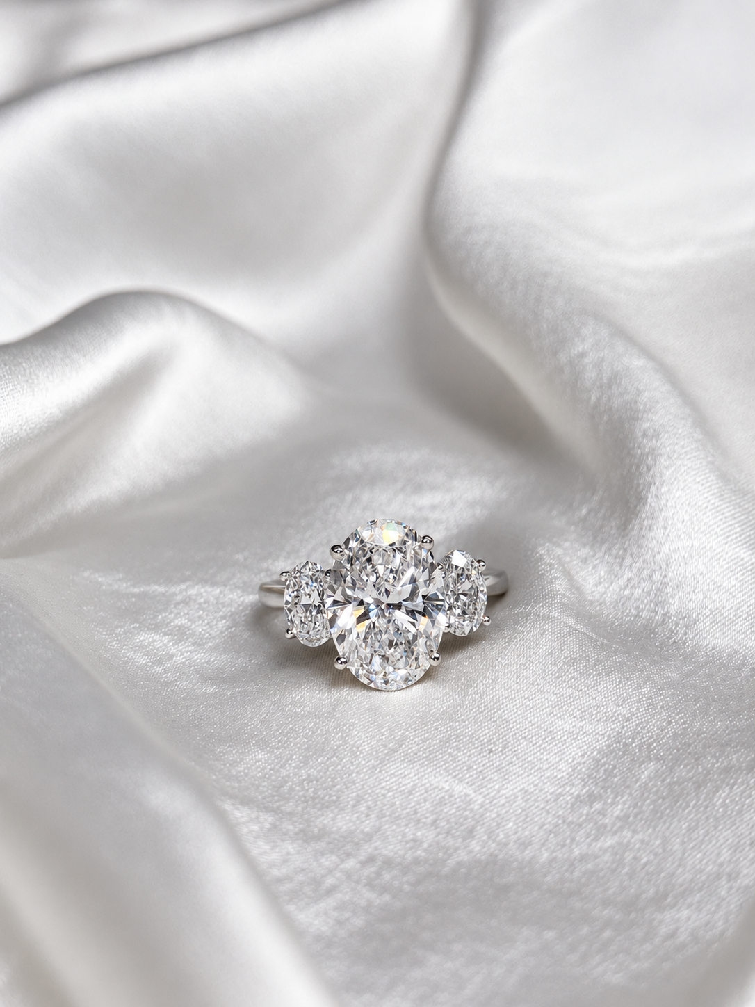 Three-stone oval lab gown engagement ring